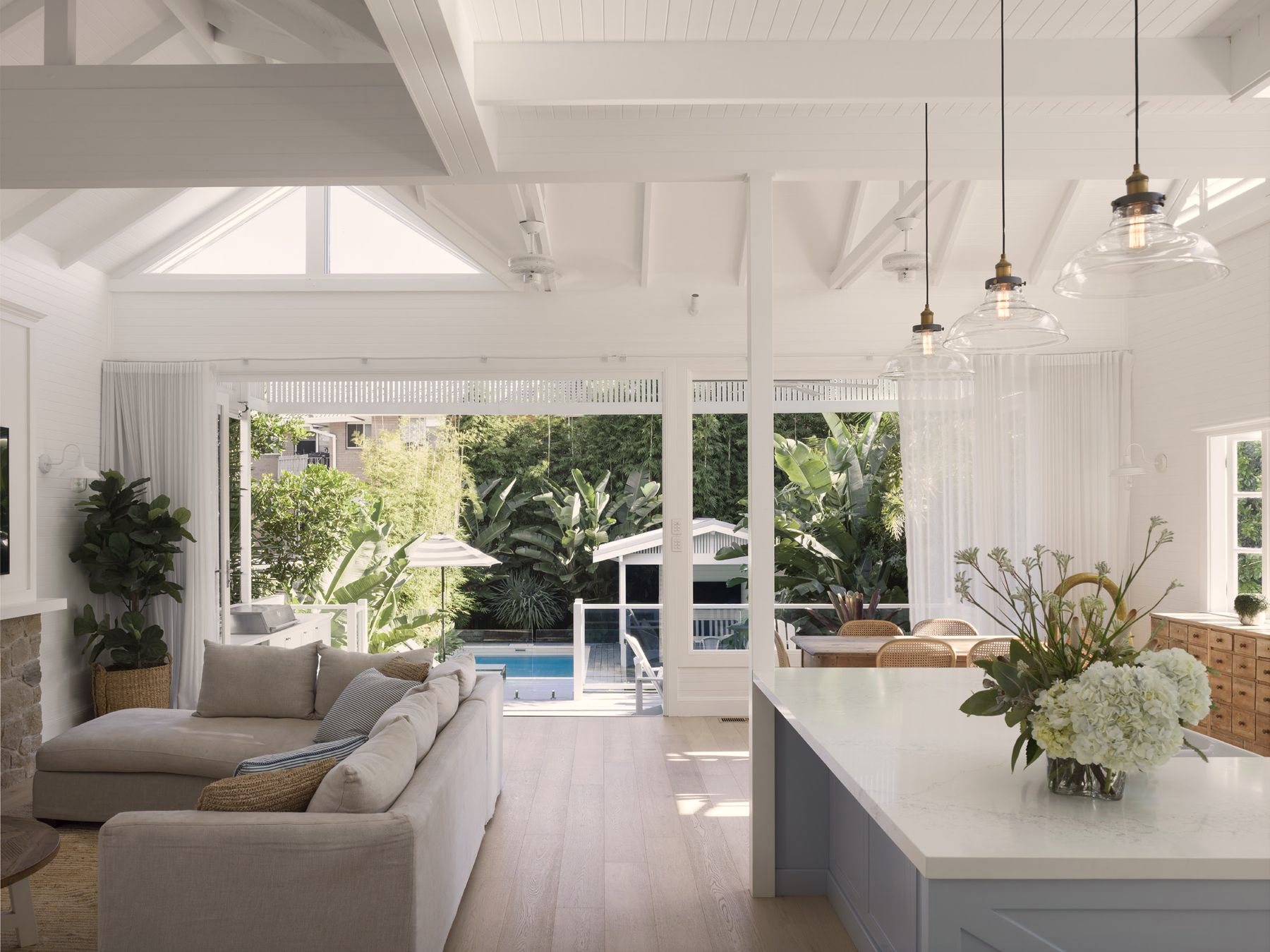 Open living and kitchen opening to the pool