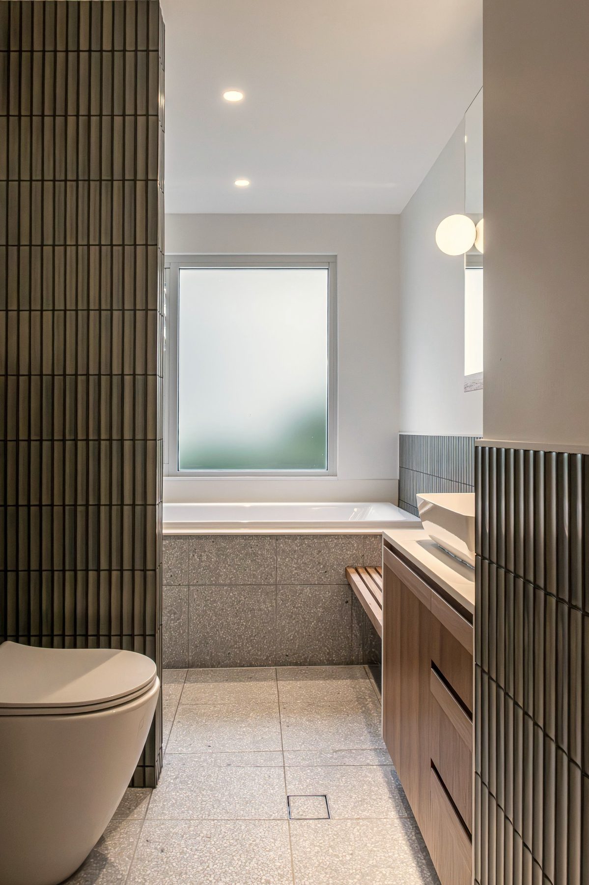 Bathroom with green finger tiles and terrazzo