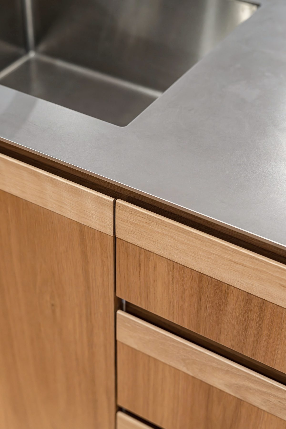 Steel benchtop meeting timber drawer fronts